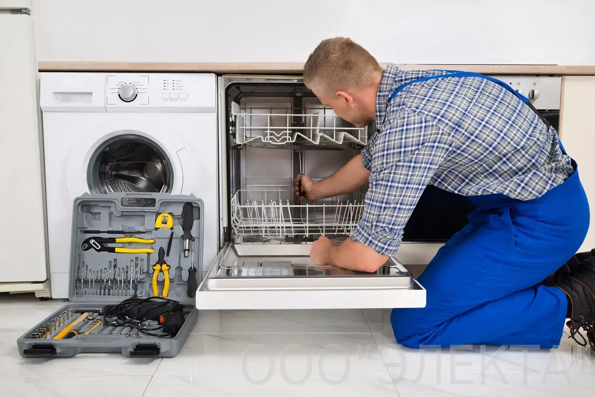 Ramson Appliances technician repairing a built-in dishwasher in a Groveland, FL kitchen
