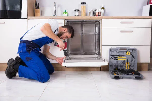 Ramson Appliances technician testing dishwasher controls during a repair in Groveland, FL