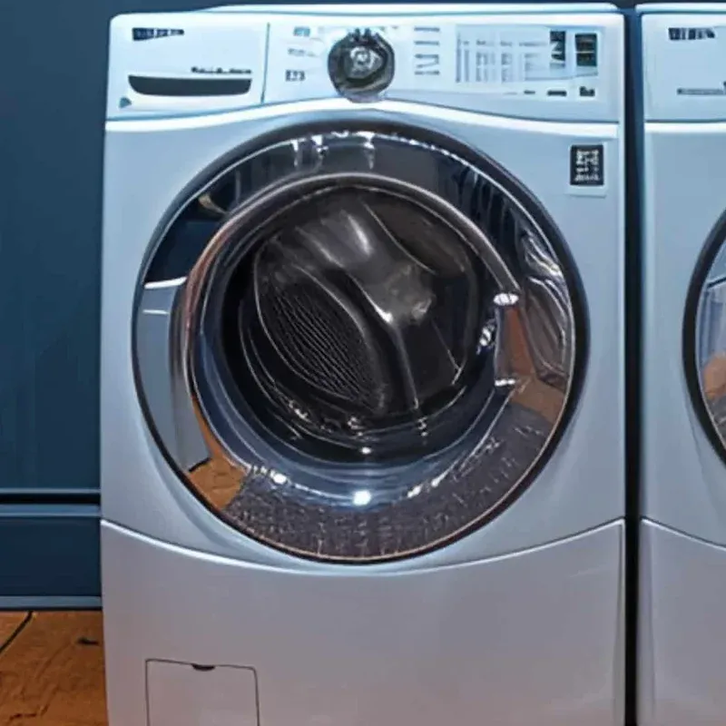 Silver front-load washer and dryer pair in a laundry room with navy cabinets