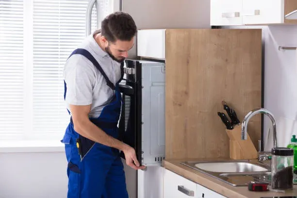 Ramson Appliances technician repairing a built-in oven door