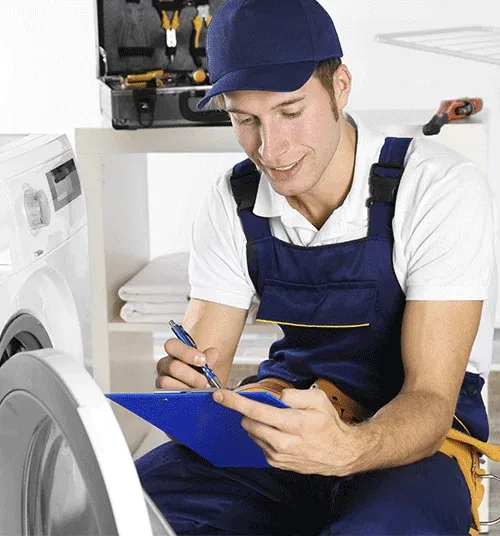 Ramson Appliances technician writing up a GE washer diagnosis for a Groveland customer