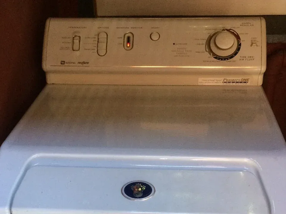 Maytag Neptune dryer with the moisture monitor light on in its control panel