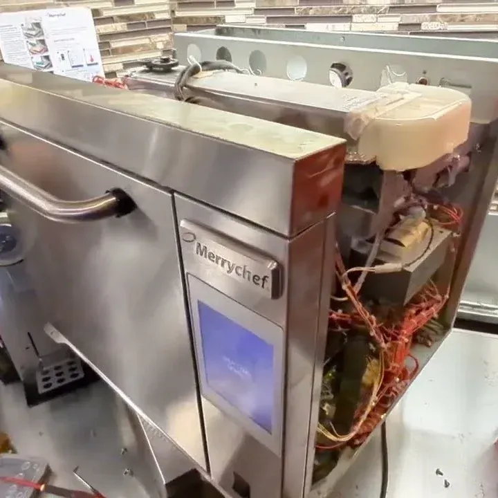 Merrychef high-speed oven with its side panel off, showing the wiring