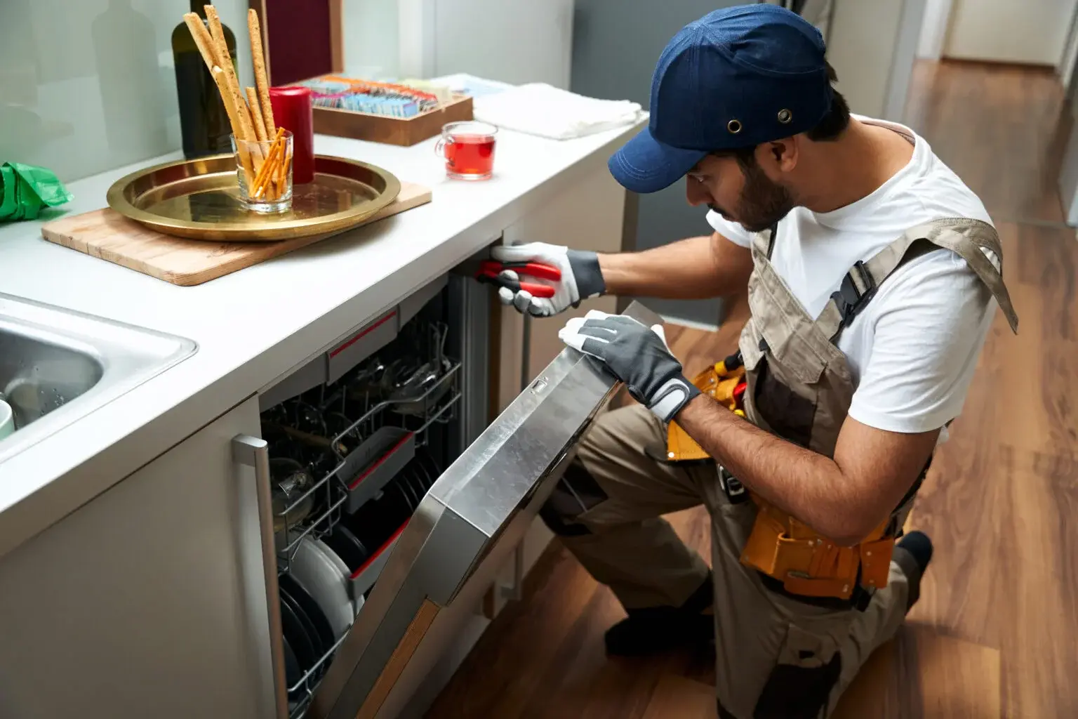 Ramson Appliances technician repairing a dishwasher in a Groveland, FL kitchen