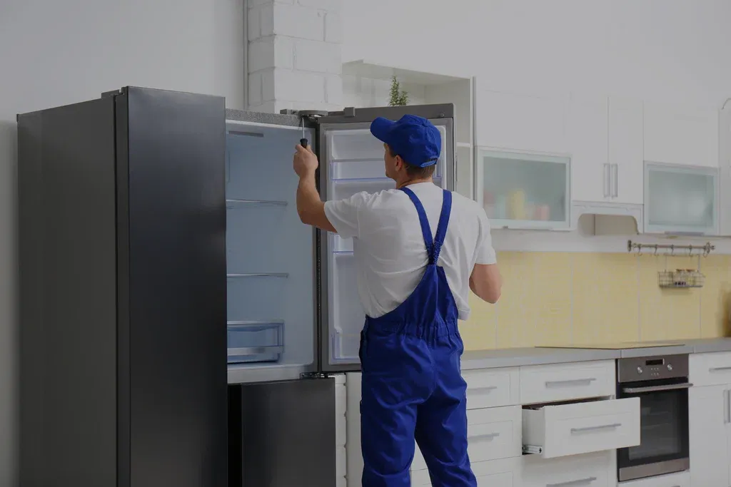 Ramson Appliances technician installing a French door refrigerator in a Groveland kitchen
