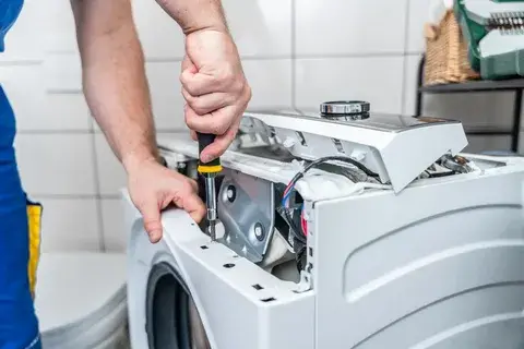 Ramson Appliances technician repairing a home appliance in a Groveland, FL kitchen