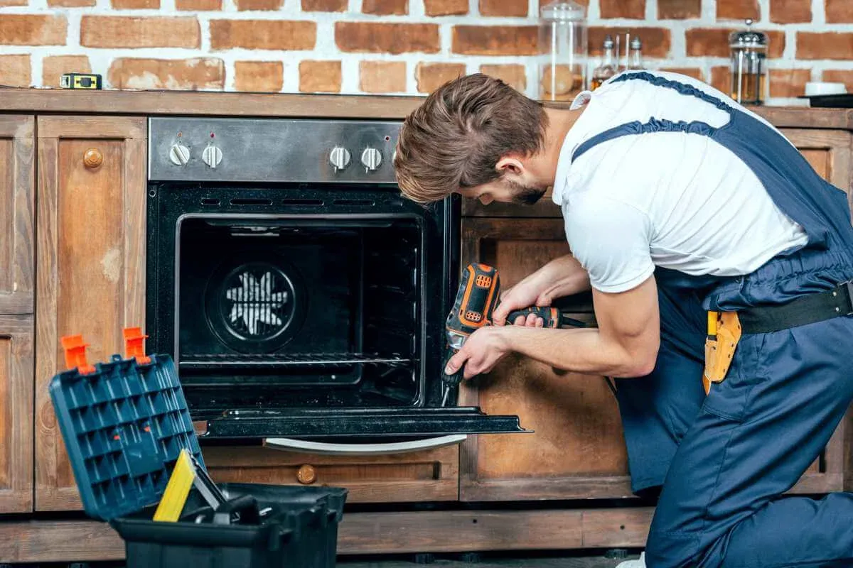 Technician servicing a kitchen range on a same-day repair in Groveland, FL