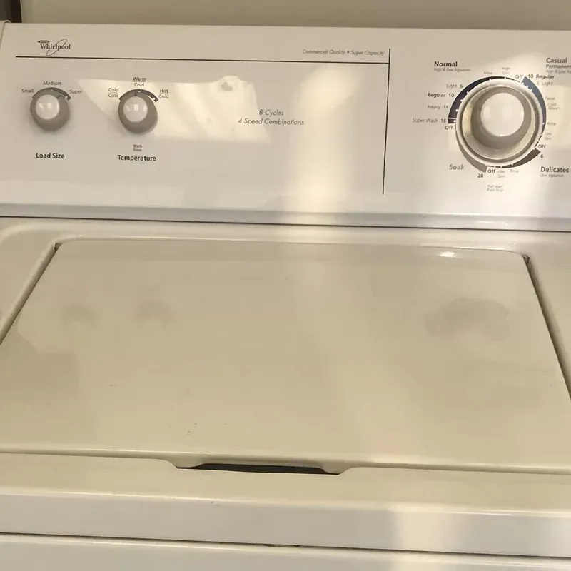 Control panel and lid of a white Whirlpool top-load washer