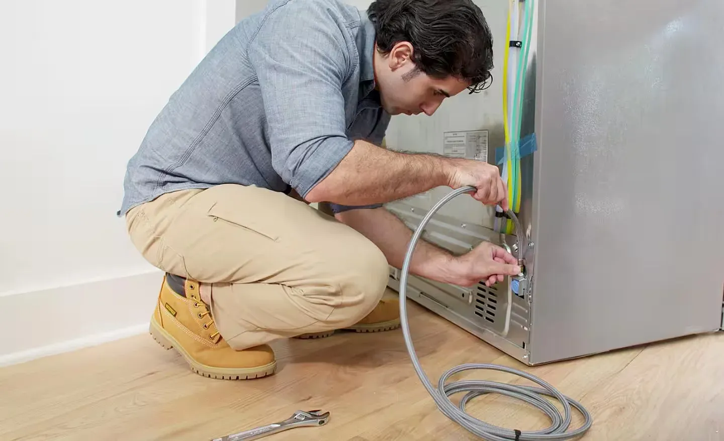 Ramson Appliances technician connecting a refrigerator water line in Groveland, FL